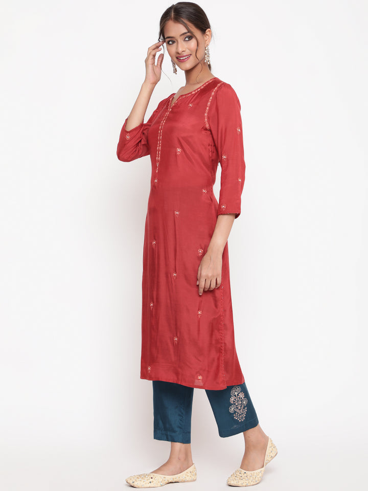 Woman posing in Savi’s Shantoon Embroidered Ethnic Rust Kurta with Contrast Pant Set