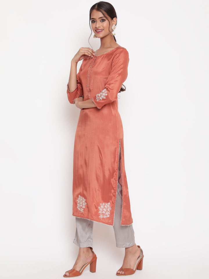 Woman posing in Rust Embroidered Straight Kurta Pant Set