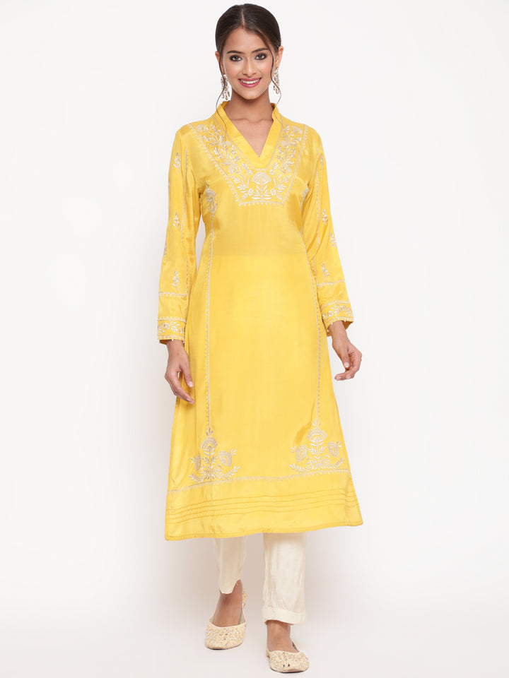 Woman posing in Savi’s Shantoon Embroidered Mustard Straight Kurta With Solid Pant