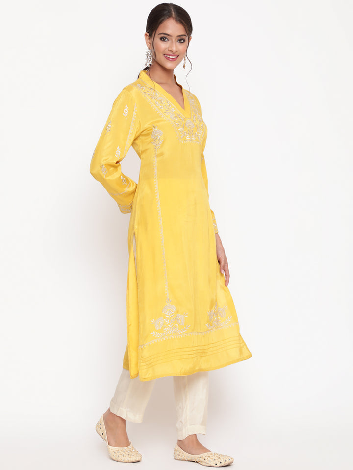 Woman posing in Savi’s Shantoon Embroidered Mustard Straight Kurta With Solid Pant