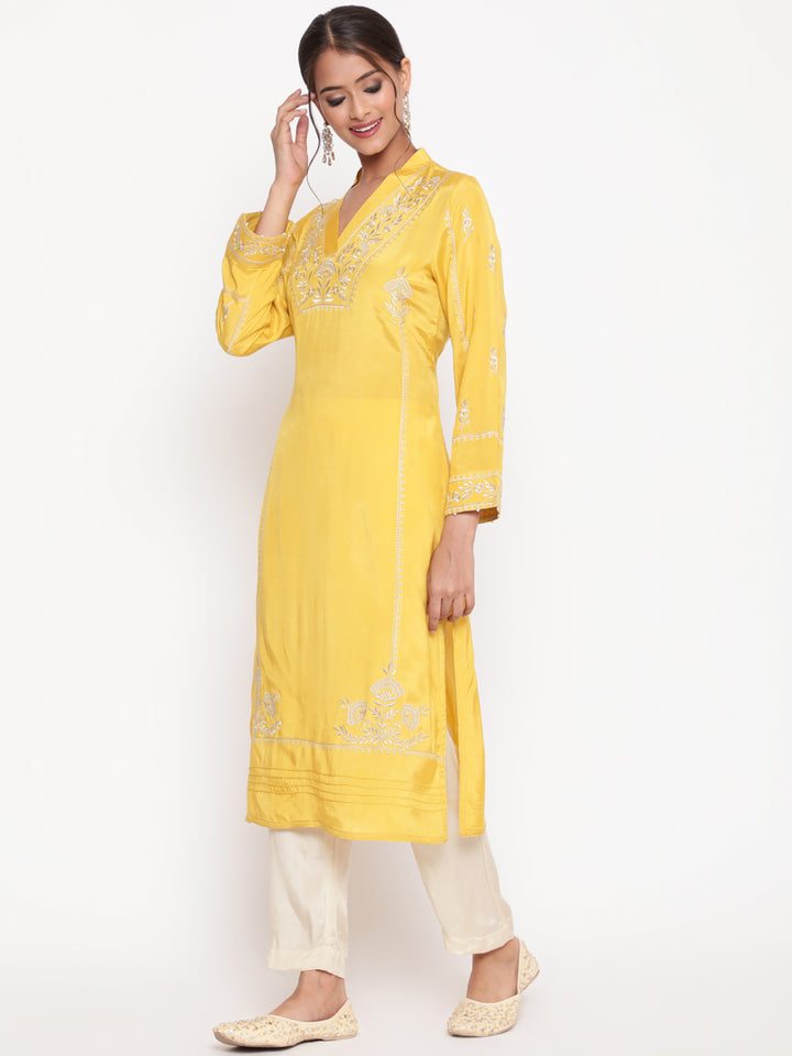 Woman posing in Savi’s Shantoon Embroidered Mustard Straight Kurta With Solid Pant