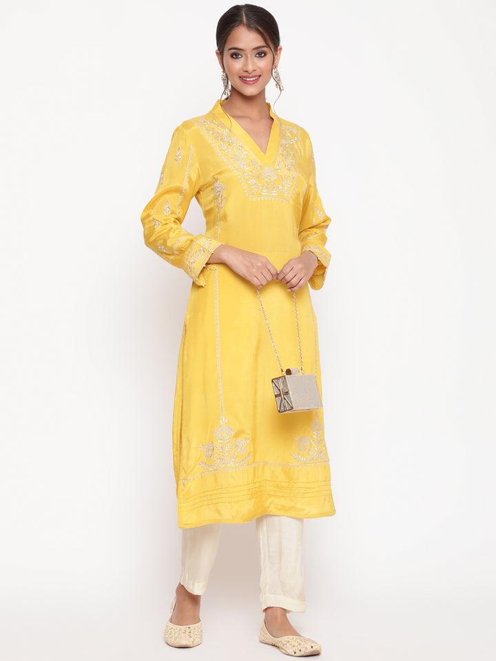 Woman posing in Savi’s Shantoon Embroidered Mustard Straight Kurta With Solid Pant