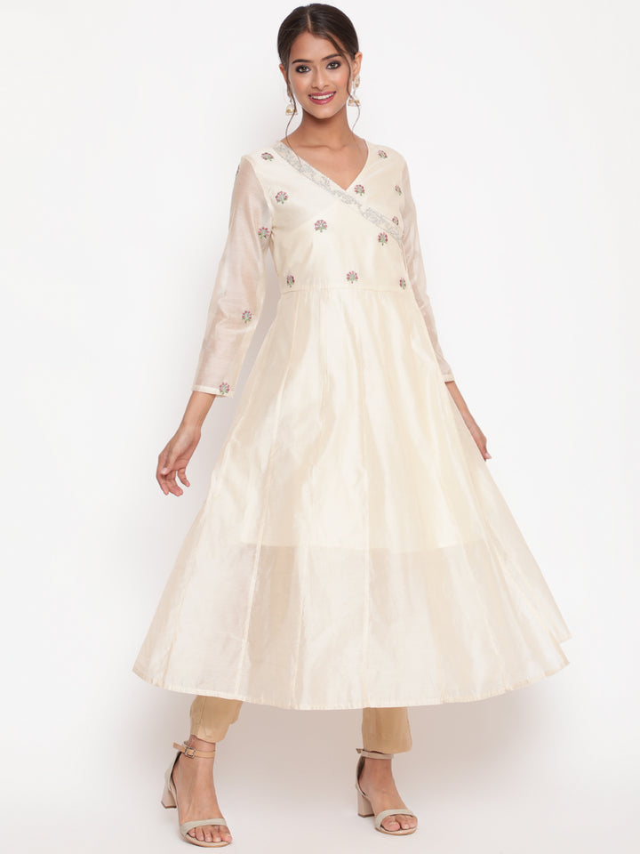 Woman posing in Savi's Silk Chanderi Ethnic Motif Embroidered Off White Angrakha Kurta