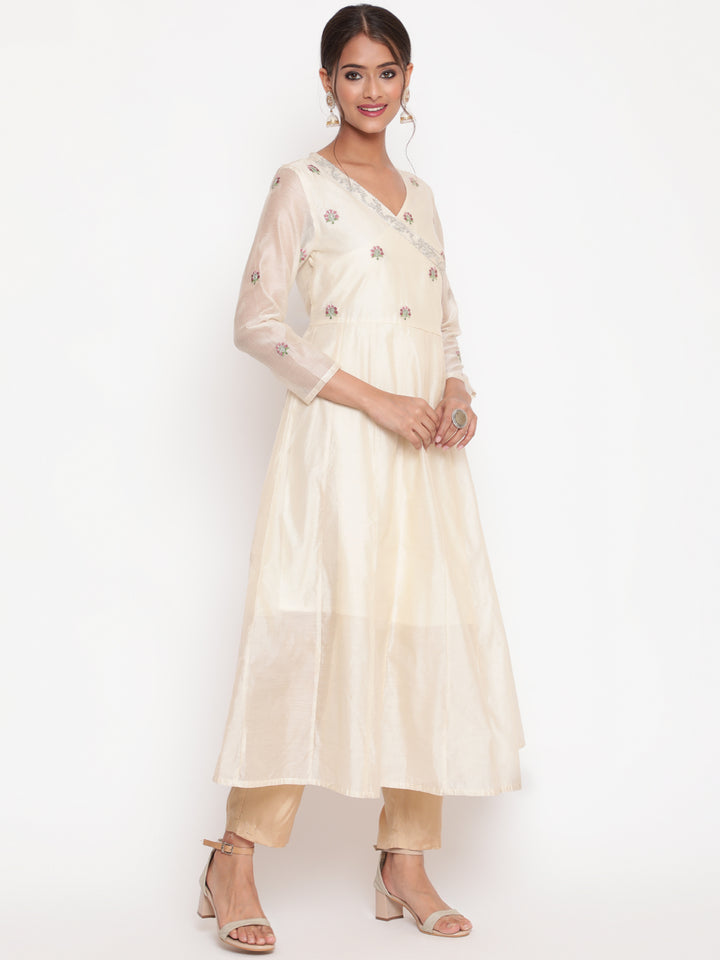 Woman posing in Savi's Silk Chanderi Ethnic Motif Embroidered Off White Angrakha Kurta