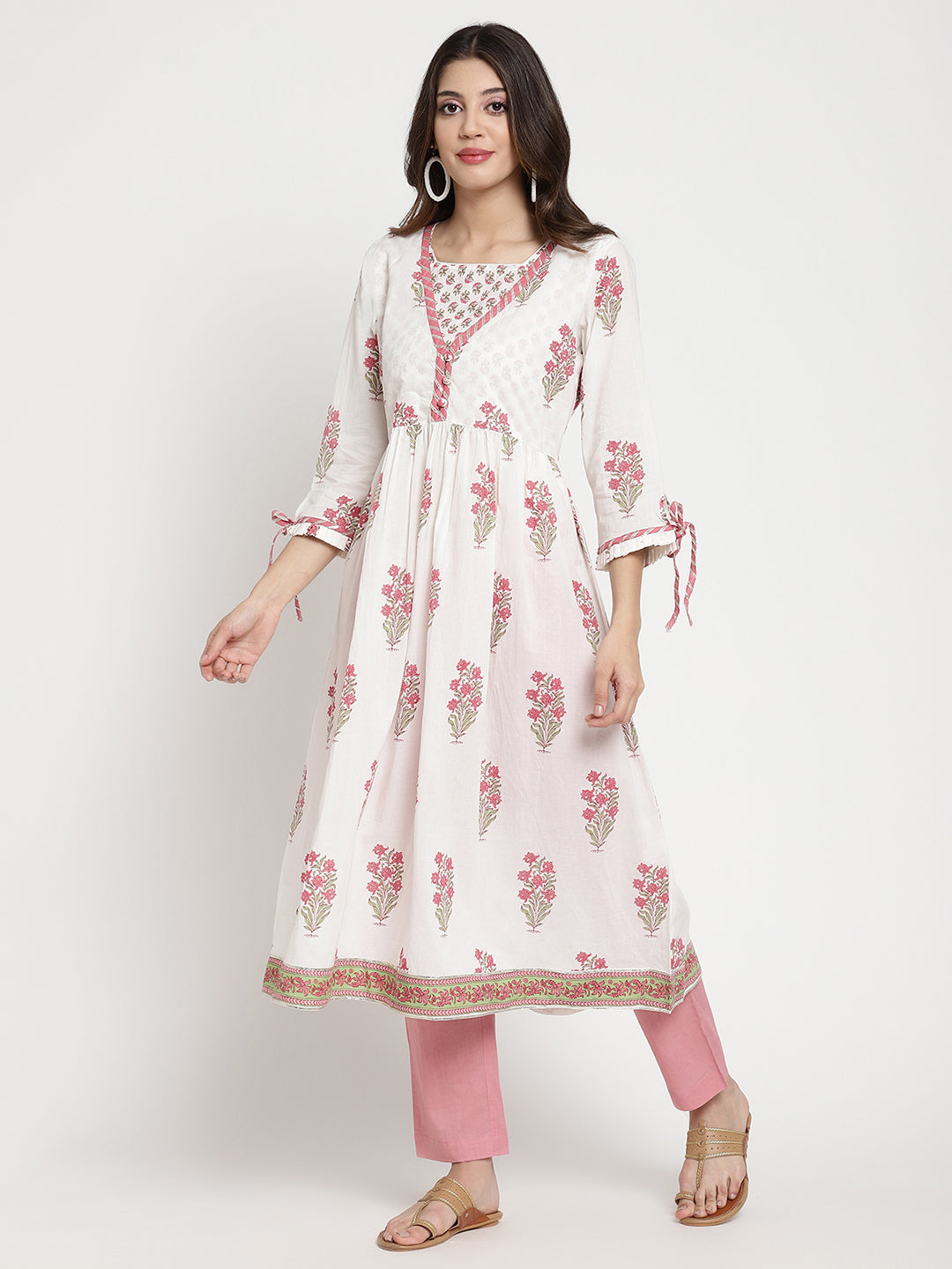 Woman posing in a white cotton Kurta that has a flared hemline.