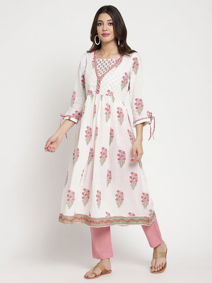 Woman posing in a white cotton Kurta that has a flared hemline.
