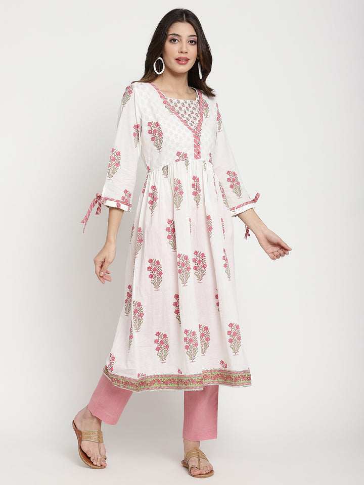 Woman posing in a white cotton Kurta that has a flared hemline.