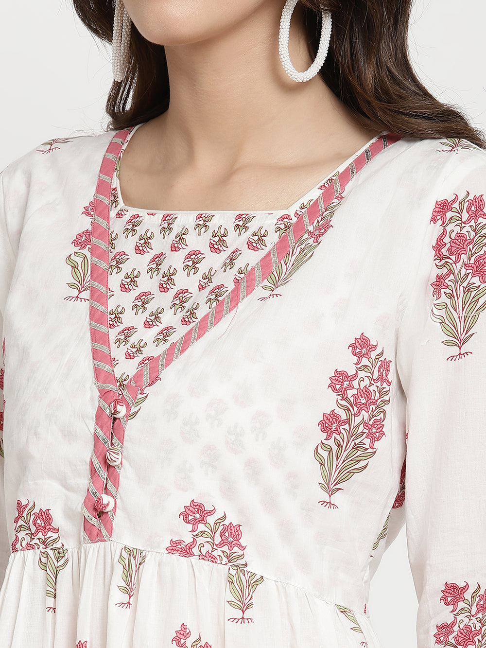 Woman posing in a white cotton Kurta that has a flared hemline.