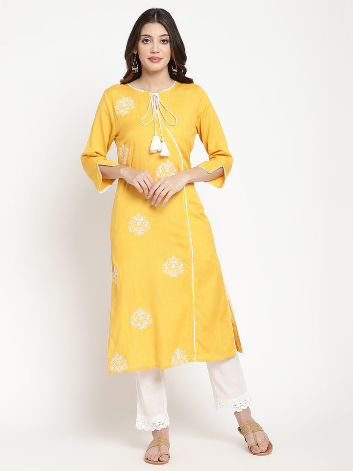 'Woman posing in yellow embroidered Angrakha Kurta Pant Set.