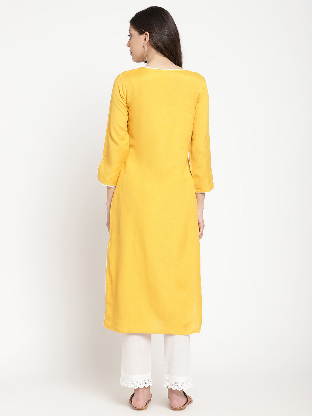 'Woman posing in yellow embroidered Angrakha Kurta Pant Set.