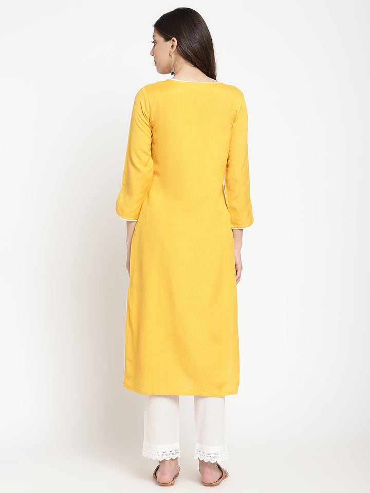 'Woman posing in yellow embroidered Angrakha Kurta Pant Set.