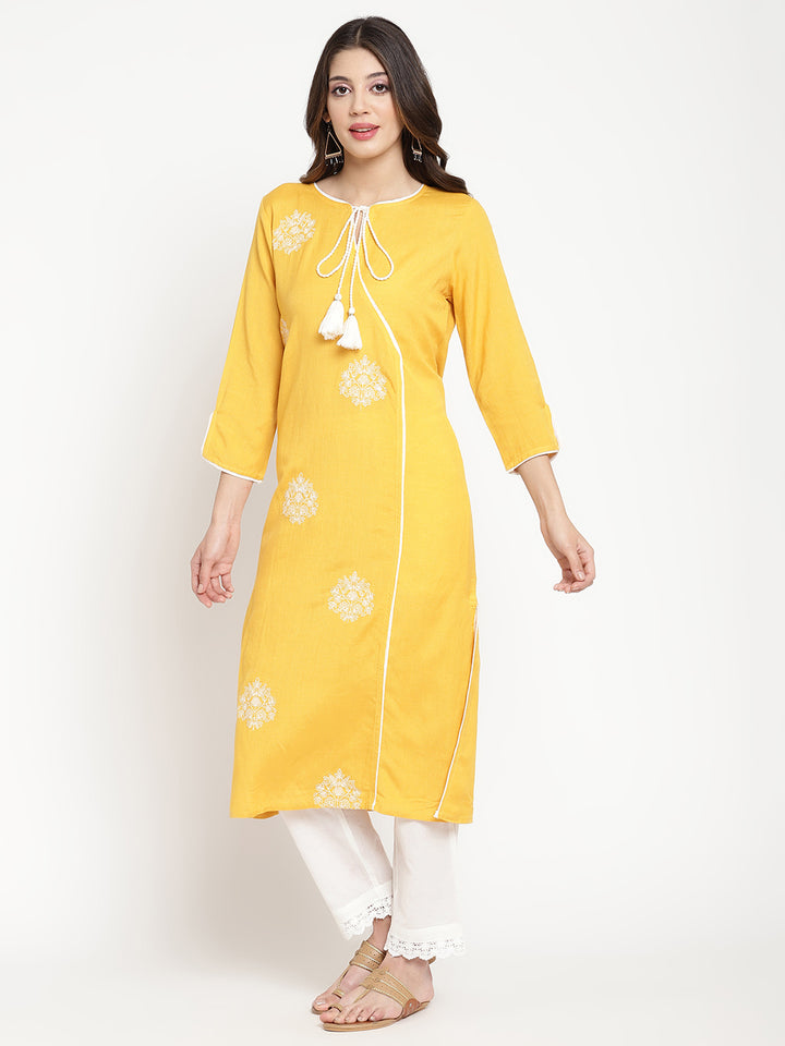 'Woman posing in yellow embroidered Angrakha Kurta Pant Set.