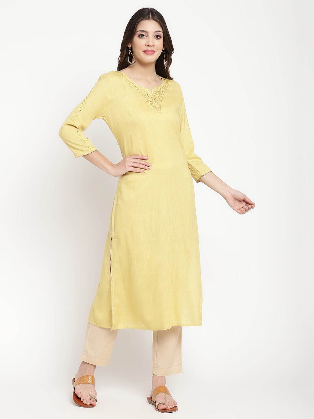Woman wearing a yellow rayon, straight-fit Kurta.