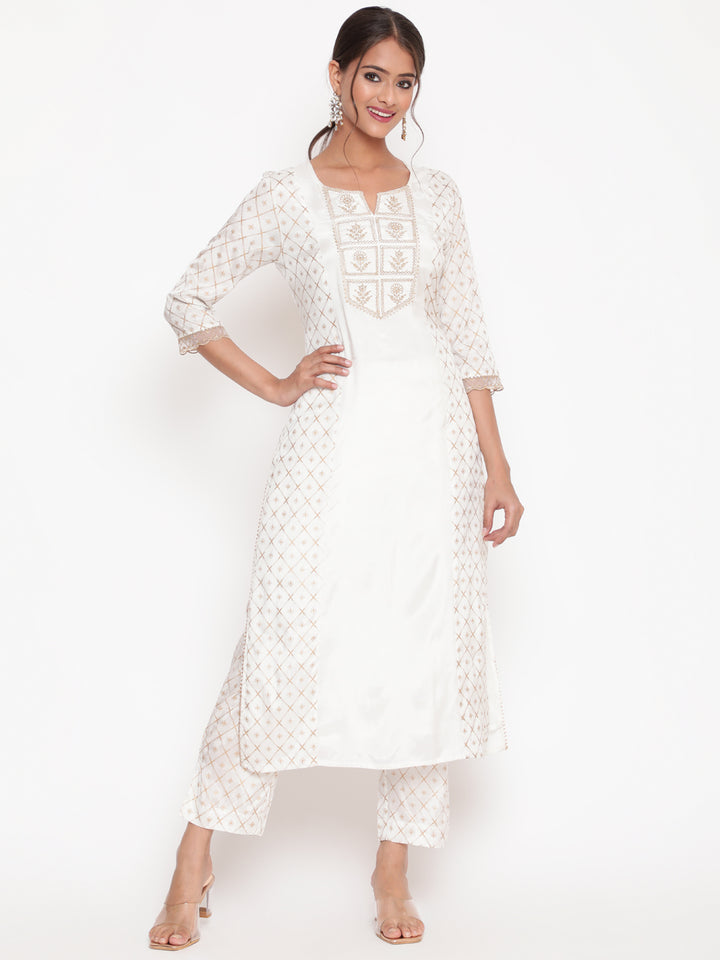 Woman posing in Savi’s Shantoon Printed and Embroidered Off White Kurta Pant Set