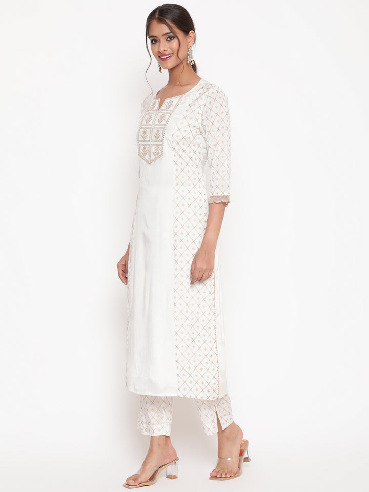 Woman posing in Savi’s Shantoon Printed and Embroidered Off White Kurta Pant Set