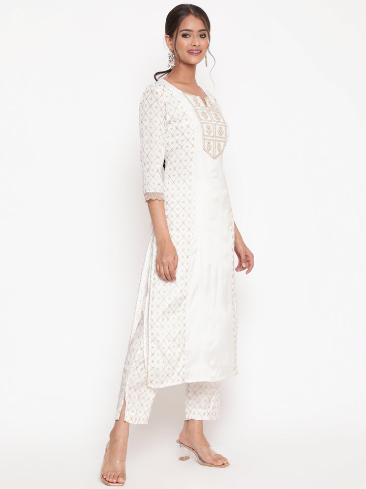 Woman posing in Savi’s Shantoon Printed and Embroidered Off White Kurta Pant Set