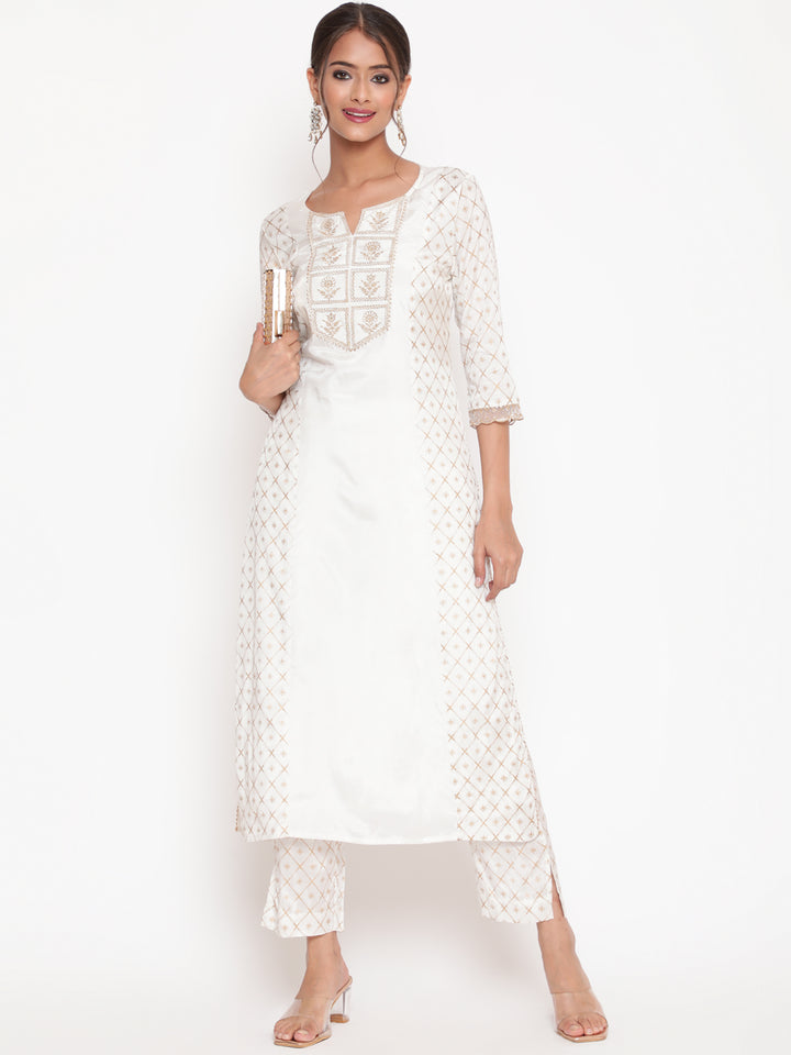 Woman posing in Savi’s Shantoon Printed and Embroidered Off White Kurta Pant Set