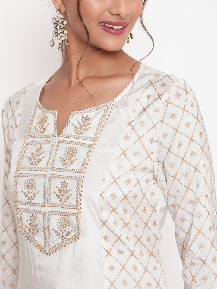 Woman posing in Savi’s Shantoon Printed and Embroidered Off White Kurta Pant Set