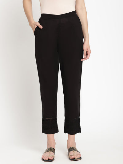 Wide shot of black cotton pintuck pants for women. 