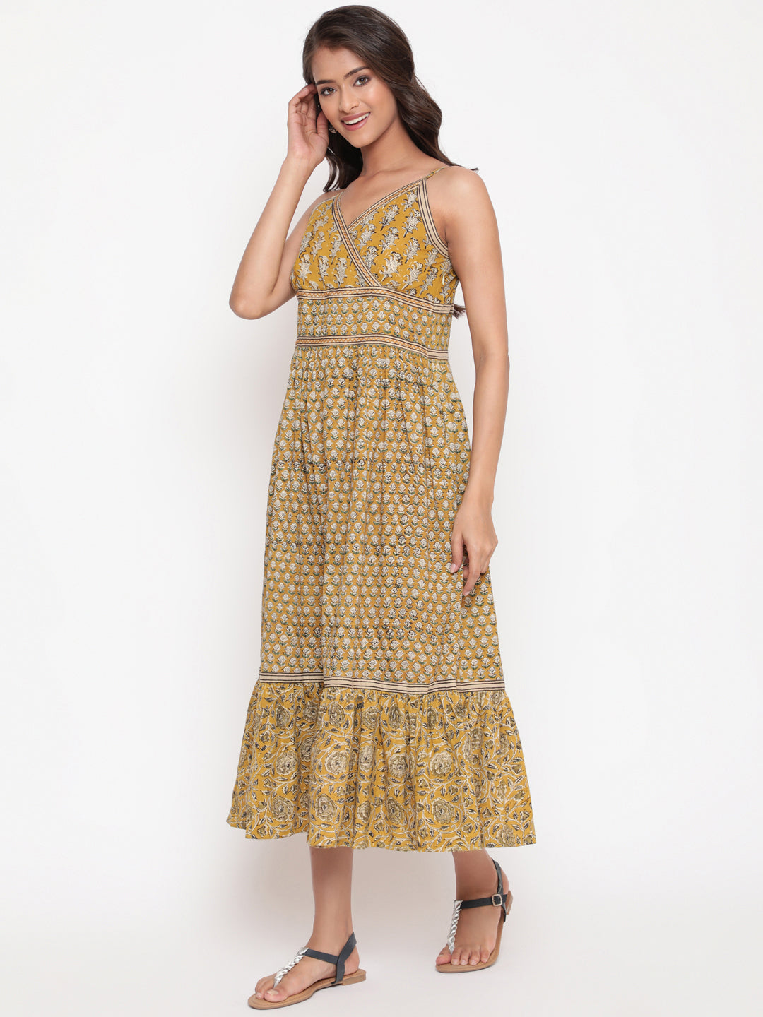Woman posing in Savi's Cotton hand block inspired printed strappy mustard flared dress