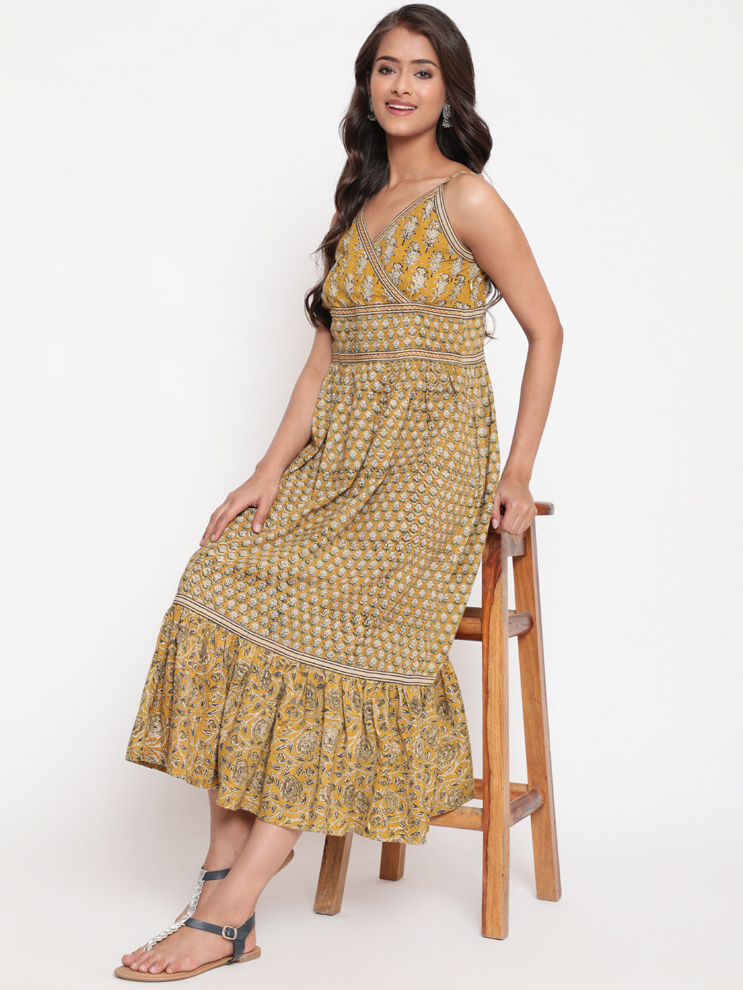 Woman posing in Savi's Cotton hand block inspired printed strappy mustard flared dress