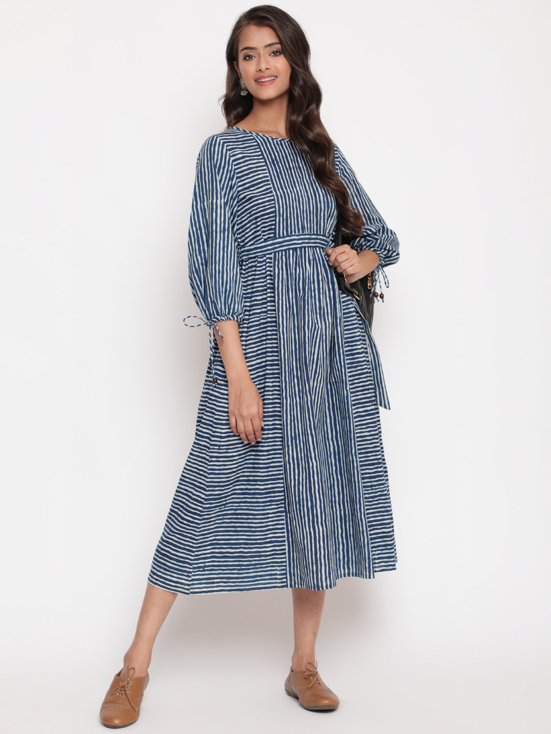 Woman posing in Savi's Cotton indigo Printed Striped Tie up designer Dress