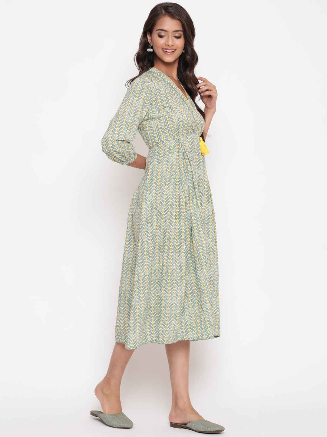 Woman posing in Savi's Cotton overlap Yoke sage Green Pleated Dress