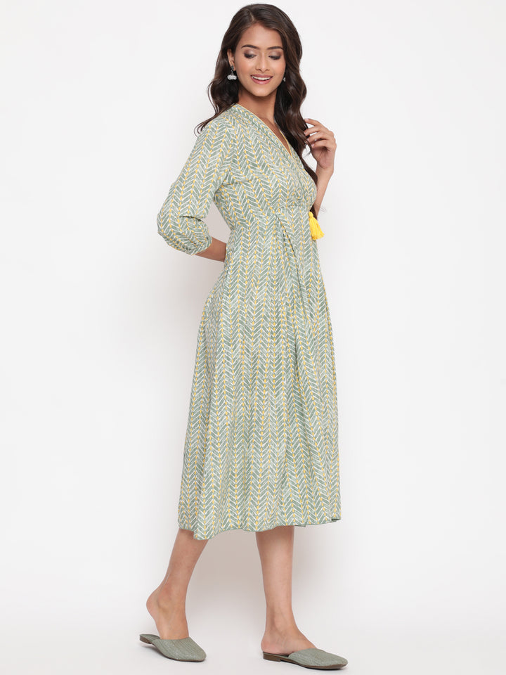 Woman posing in Savi's Cotton overlap Yoke sage Green Pleated Dress