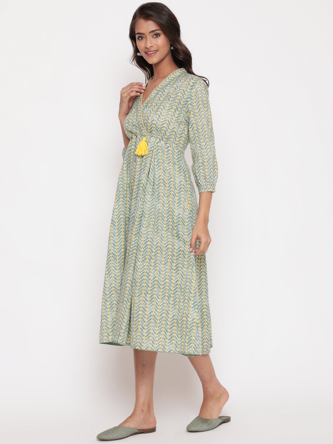 Woman posing in Savi's Cotton overlap Yoke sage Green Pleated Dress