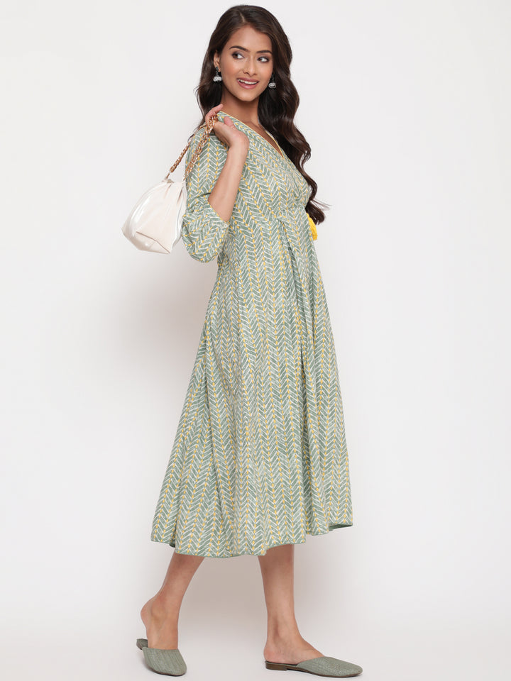 Woman posing in Savi's Cotton overlap Yoke sage Green Pleated Dress