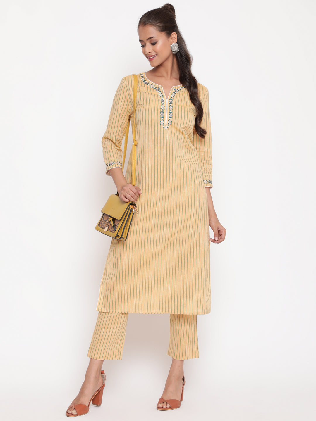 Woman posing in Savi's Cotton yarn dye Yellow Straight fit kurta With Pant