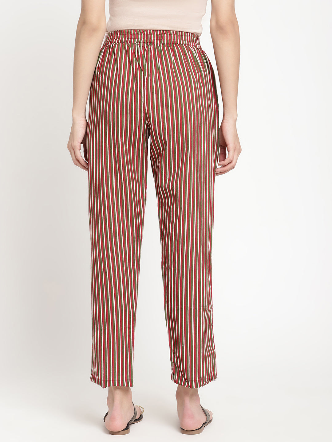 Woman wearing dark brown striped pants made of cotton fabric. 