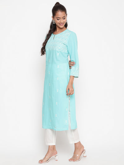 Woman posing in Embroidered Sky Blue Cotton Straight Fit Kurta by Savi