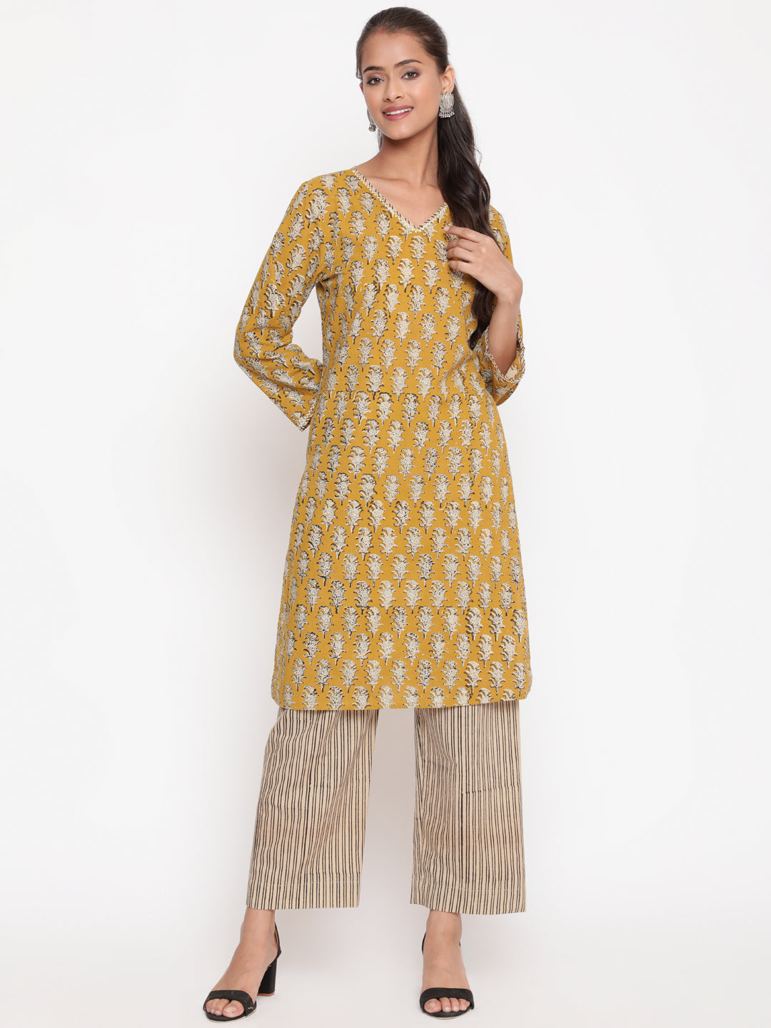 Woman posing in Savi's Cotton Printed Yellow Kurta Pant set