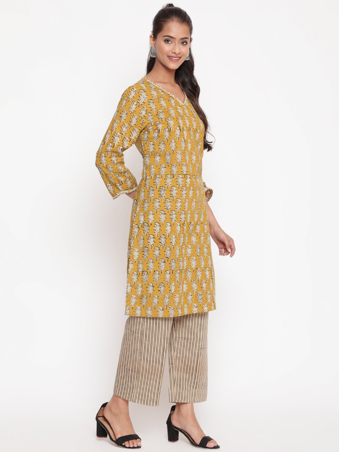 Woman posing in Savi's Cotton Printed Yellow Kurta Pant set