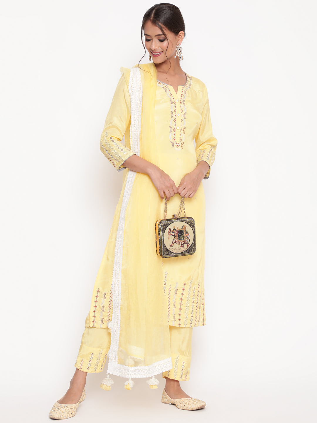 Woman posing in Savi’s Embroidered Yellow Shantoon Kurta Pant set With Dupatta