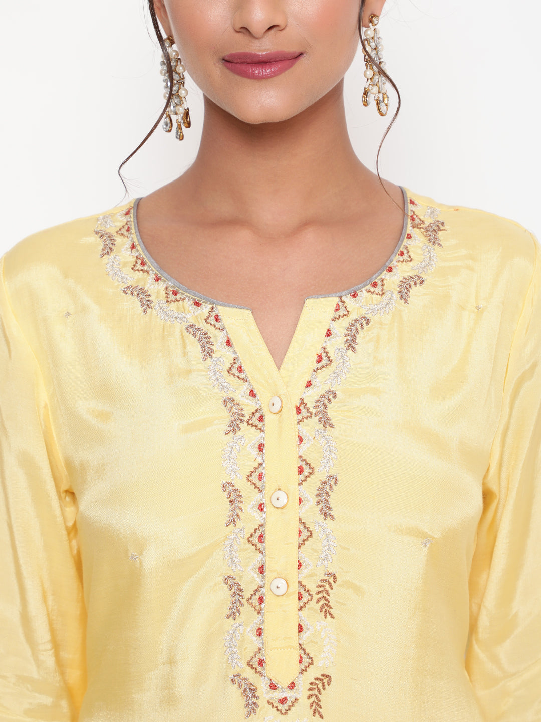 Woman posing in Savi’s Embroidered Yellow Shantoon Kurta Pant set With Dupatta