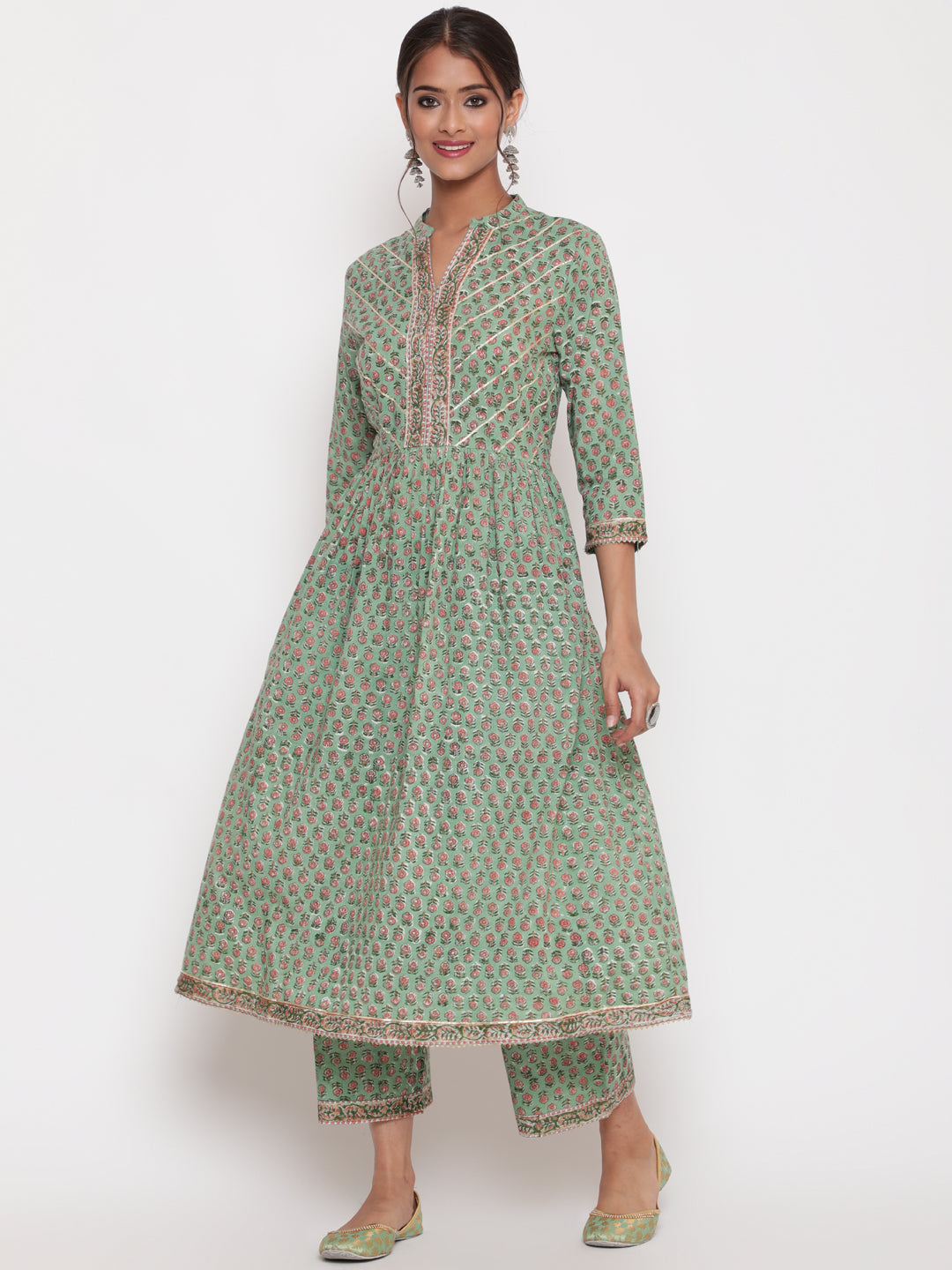 "Woman posing in Savi's Cotton Embellished Sage Green A Line Flared Kurta pant Set
