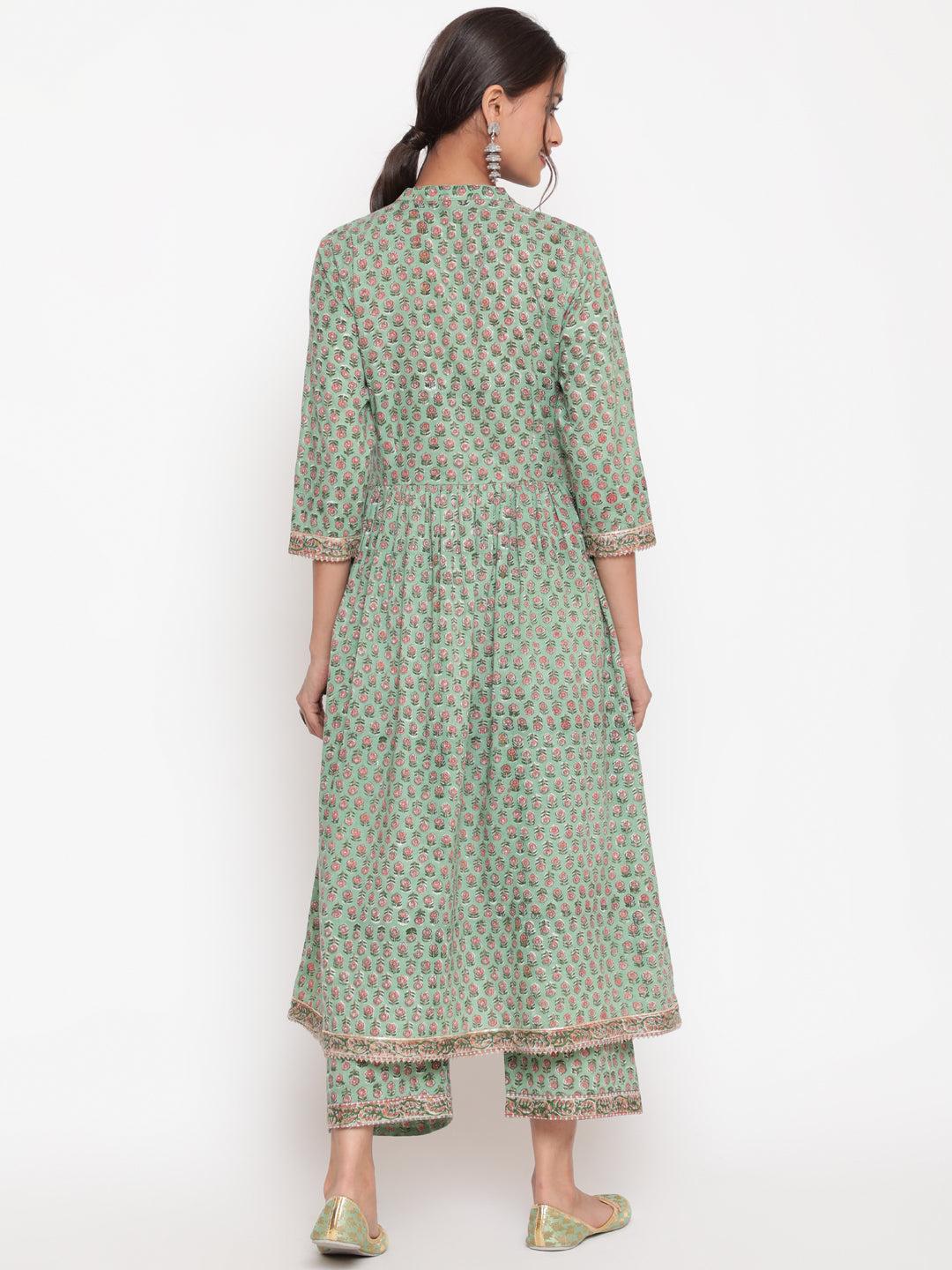 Woman posing in Savi's Cotton Embellished Sage Green A Line Flared Kurta pant Set