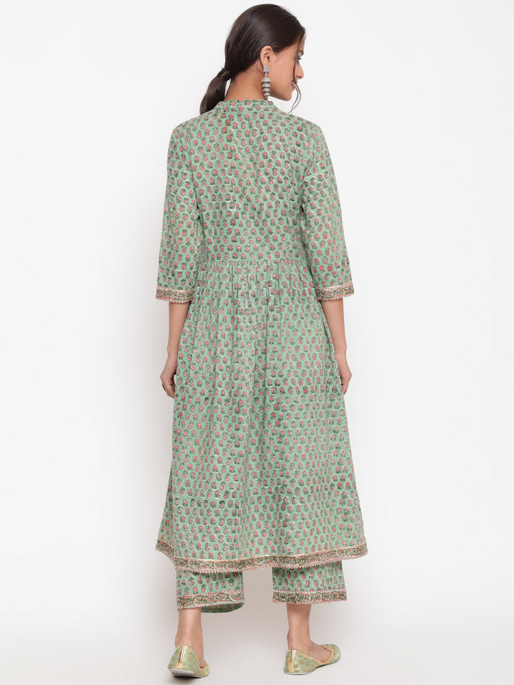 Woman posing in Savi's Cotton Embellished Sage Green A Line Flared Kurta pant Set