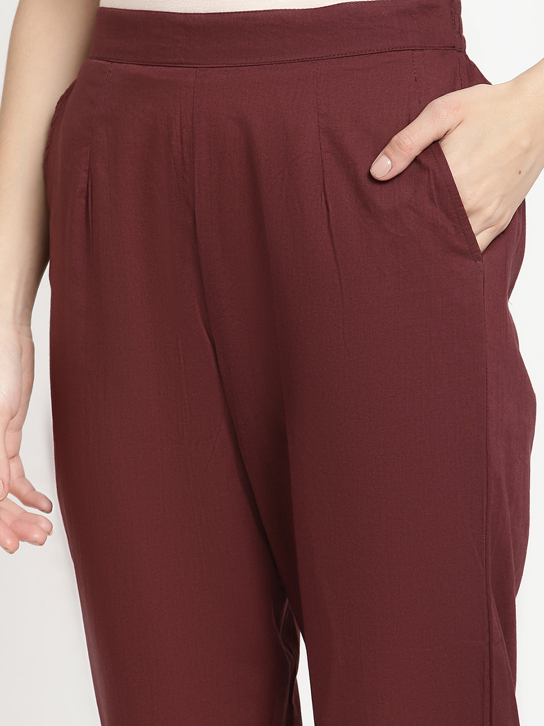 Model wearing straight-fit maroon cotton pants. 