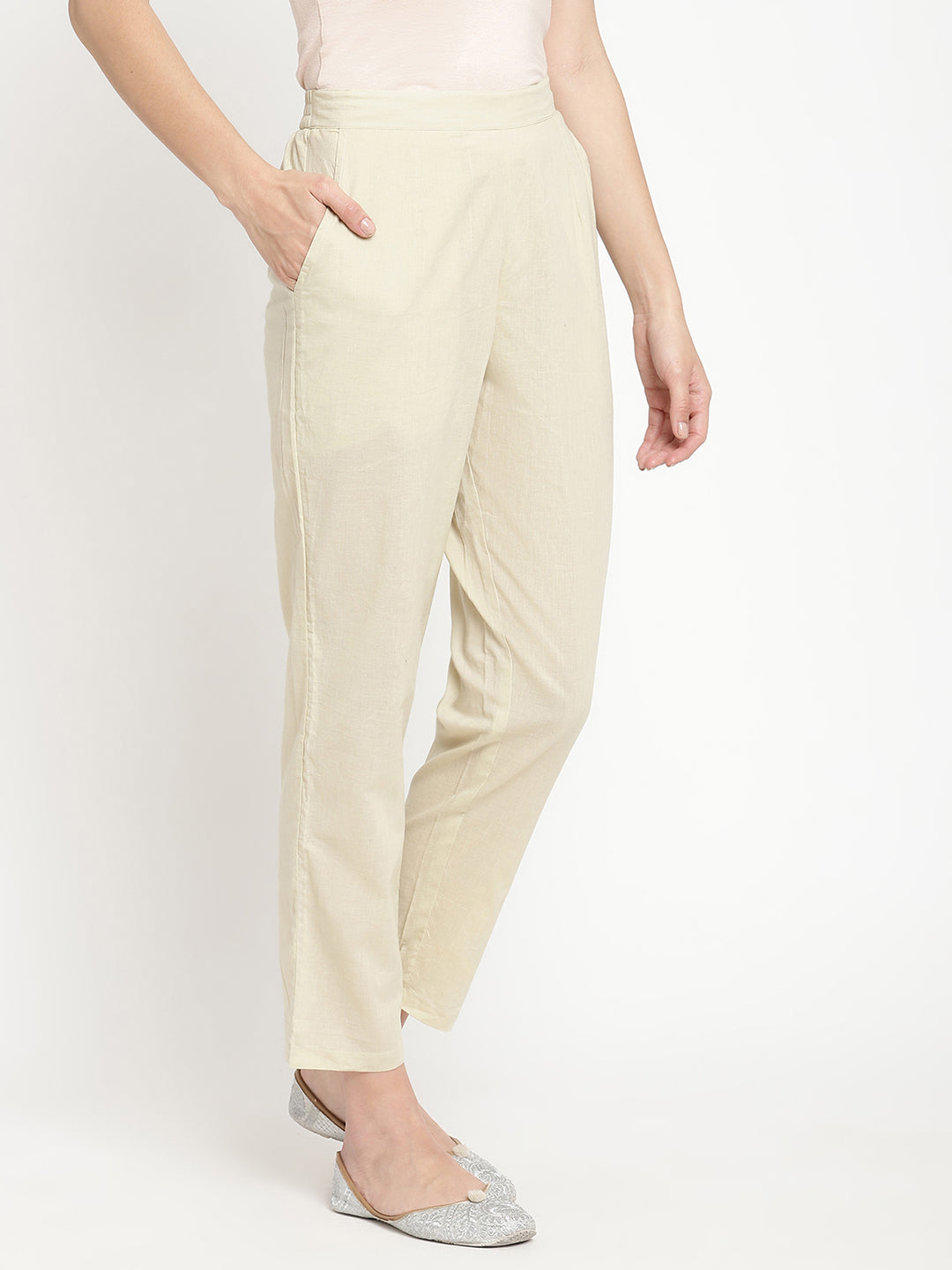 Full shot of straight-fit, off-white pants for women. 