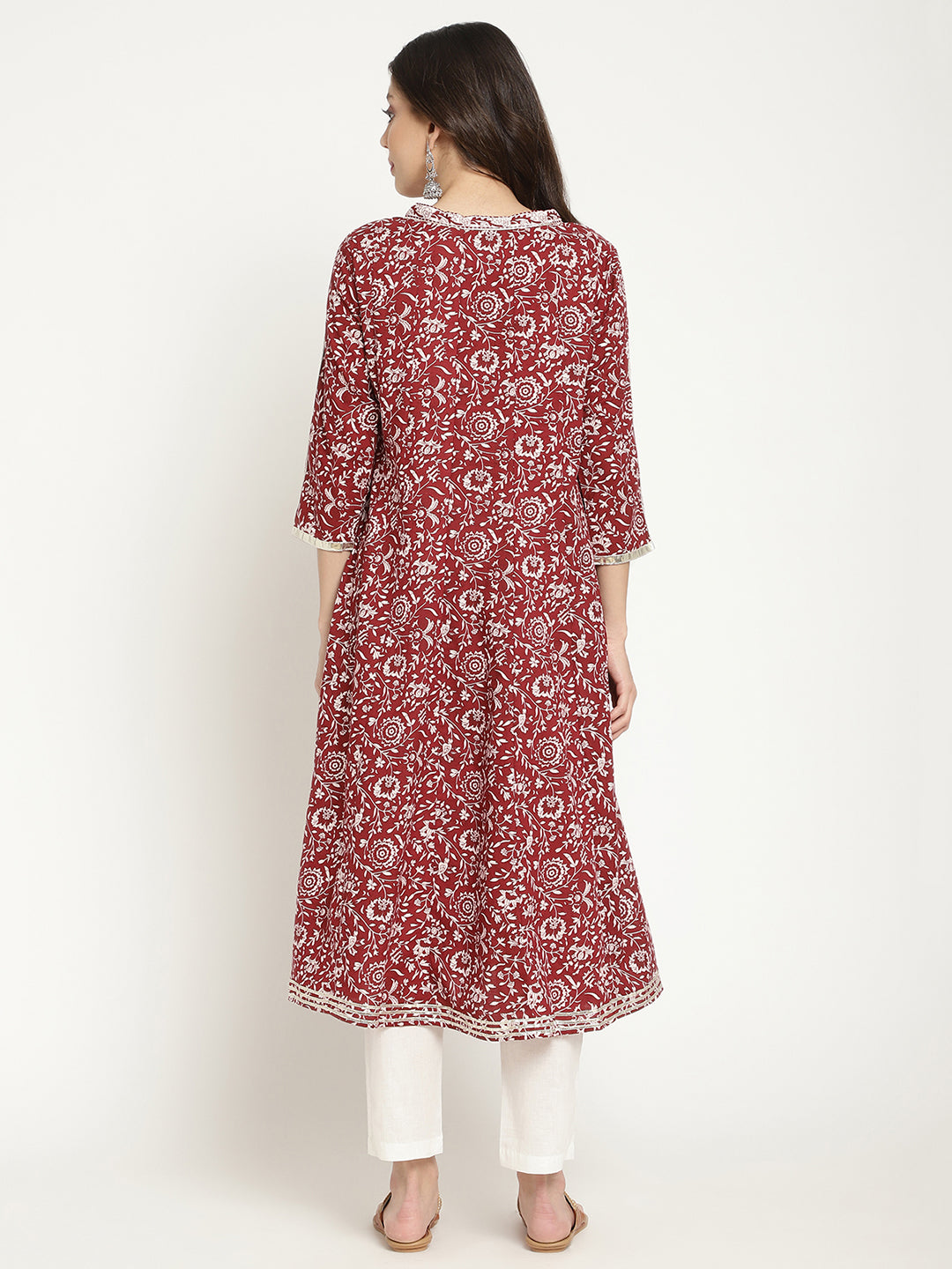 Woman posing in a flared Kurta against a white background. 