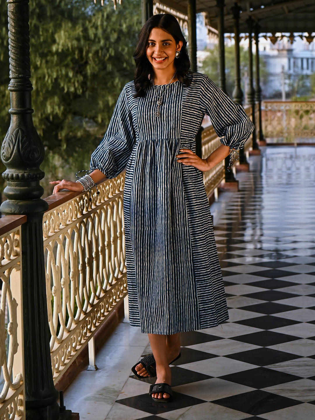 Woman posing in Savi's Cotton indigo Printed Striped Tie up designer Dress