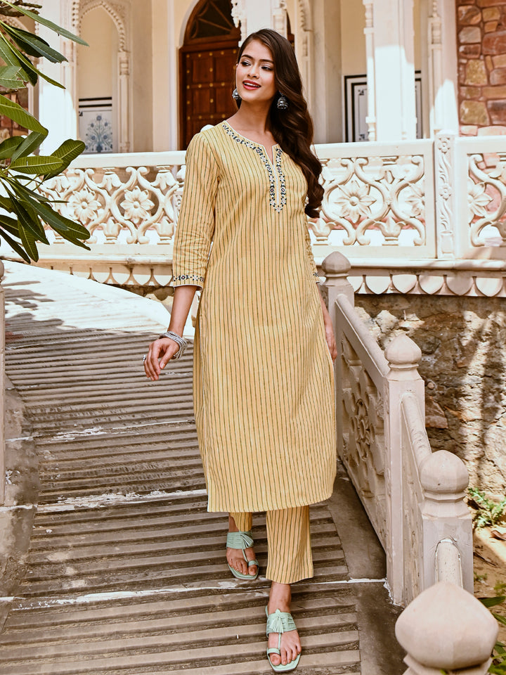 Woman posing in Savi's Cotton yarn dye Yellow Straight fit kurta With Pant