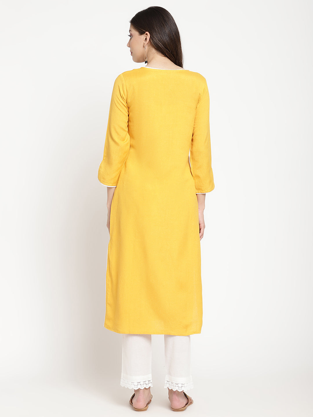 'Woman posing in yellow embroidered Angrakha Kurta Pant Set. 